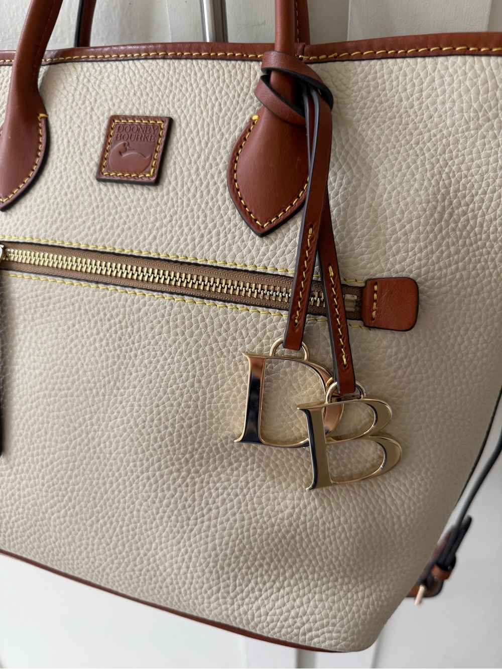 Dooney & Bourke Cream and Brown Pebbled Leather Tote with Charm - Picture 2 of 5